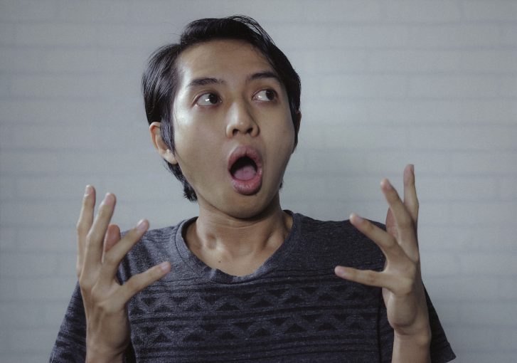 Asian man look side with amazed expression