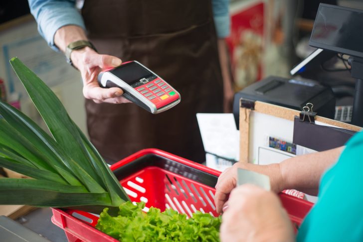 A shopper paying at the counter